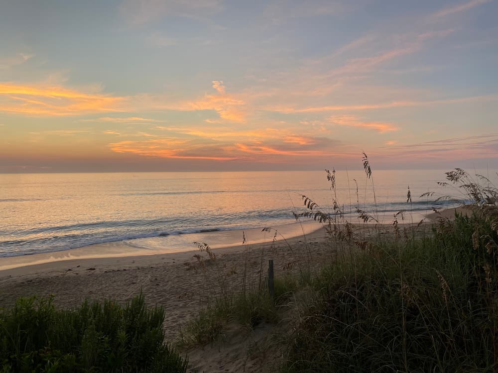 Sunset over the beach at Pawleys Island, highlighting romantic restaurants and coastal dining experiences in South Carolina.